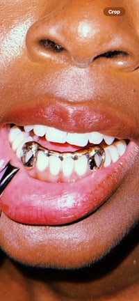 a woman is brushing her teeth